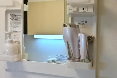 a coffeemaker sitting on a shelf in a kitchen at Karawaru Stay \u5e73\u4e95 A in Tokyo