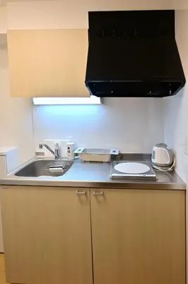 a kitchen with a sink and a counter top at Karawaru Stay \u5e73\u4e95 A in Tokyo