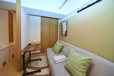 a living room with a couch and a table at Karawaru Stay \u5e73\u4e95 A in Tokyo