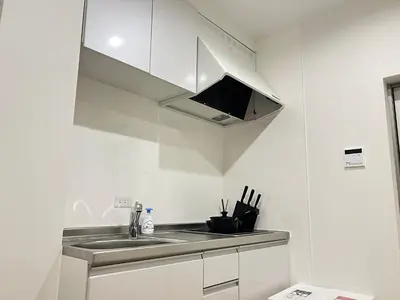 a kitchen with a sink and a microwave at Ikebukuro Area 2F3 KamiikeApartment in Tokyo