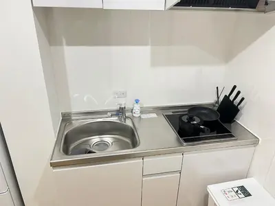 a small kitchen with a sink and a stove at Ikebukuro Area 2F3 KamiikeApartment in Tokyo