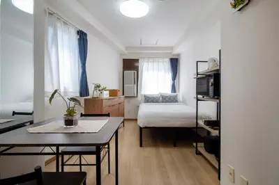 a small apartment with a bed and a table and a room at CraftFlat Komagome 605, a compact studio at excellent location in Tokyo