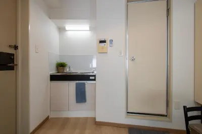 a kitchen with a sliding glass door leading to a sink at CraftFlat Komagome 605, a compact studio at excellent location in Tokyo