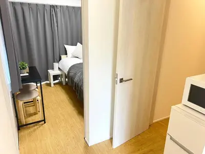 an open door to a bedroom with a bed at Ikebukuro Area 2 Units 1112 KamiikeApartment in Tokyo