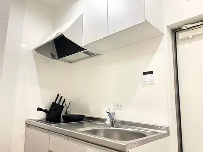 a kitchen with a sink and a microwave at Ikebukuro Area 2 Units 1112 KamiikeApartment in Tokyo