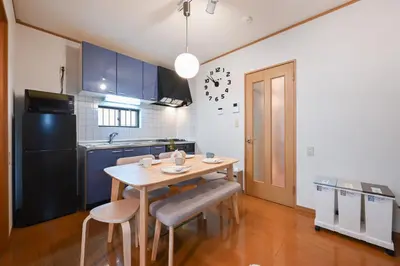 a kitchen with a wooden table and chairs in a room at Modern & Spacious Family House - 15 mins to Haneda Airport in Tokyo