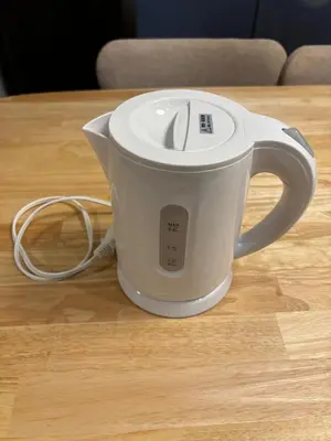 a white tea kettle sitting on a table at Modern & Spacious Family House - 15 mins to Haneda Airport in Tokyo