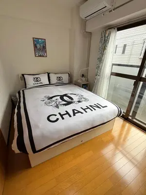 a bedroom with a bed with the word champion on it at \u6771\u4eac\u6fd5\u6696\u7684\u5bb6-Tokyo Warm Home -28 Square King Room205 in Tokyo