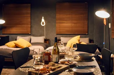 a table with a bottle of wine and food on it at Hotel-Mercurius-Azabujuban-RB in Tokyo