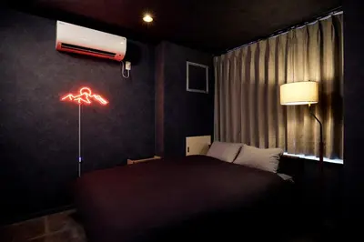 a bedroom with a bed and a air conditioner on the wall at Hotel-Mercurius-Azabujuban-RB in Tokyo