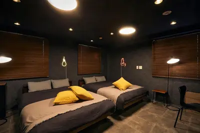 a bedroom with two beds with yellow pillows on them at Hotel-Mercurius-Azabujuban-RB in Tokyo