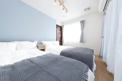 two beds sitting next to each other in a bedroom at Direct bus from Haneda 3BR House Near Station in Tokyo