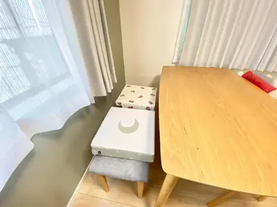 a wooden table with a stool next to a table at Direct bus from Haneda 3BR House Near Station in Tokyo