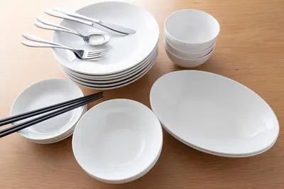 a group of white plates and silverware on a table at Direct bus from Haneda 3BR House Near Station in Tokyo
