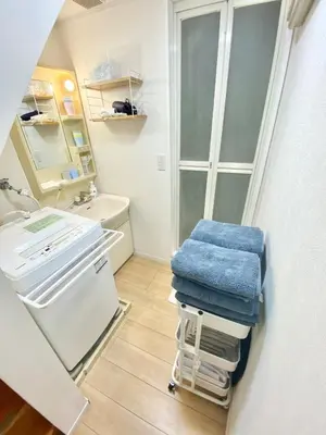 a bathroom with a sink and a toilet and towels at Direct bus from Haneda 3BR House Near Station in Tokyo