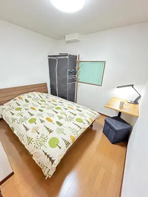 a bedroom with a bed and a desk and a table at \u8c4a\u5cf6\u5927\u585a\u3055\u304f\u3089\u6c11\u6cca in Tokyo