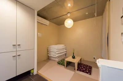 a bathroom with a table and a pile of towels at Fare Metallo Tokyo Nakano 11-room Hotel in Tokyo