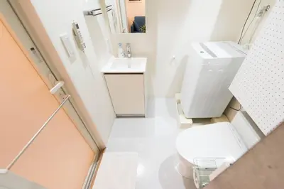 a small bathroom with a toilet and a sink at Fare Metallo Tokyo Nakano 11-room Hotel in Tokyo