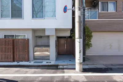 a building with a door open on a street at Fare Metallo Tokyo Nakano 11-room Hotel in Tokyo