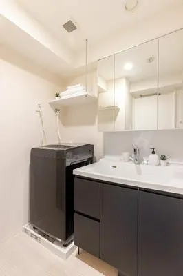 a kitchen with a sink and a black refrigerator at Arte Retreat Tokyo in Tokyo
