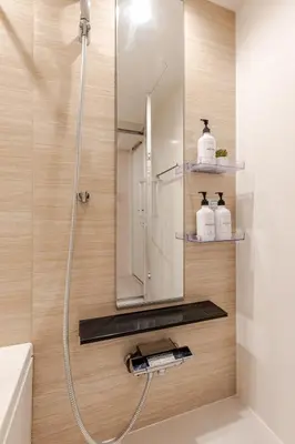 a bathroom with a shower with a mirror and a sink at Arte Retreat Tokyo in Tokyo