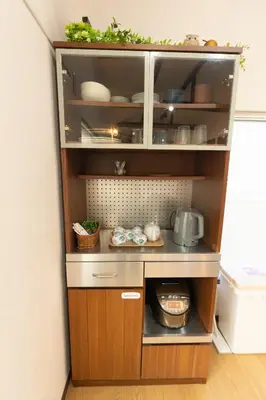 a kitchen with a shelf with food on it at Skytree-House\u4eac\u5cf6 in Tokyo