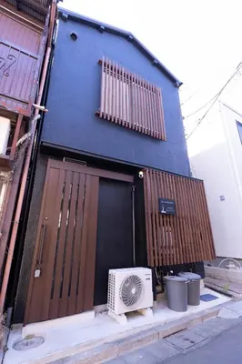 a building with a door with a fan next to it at Skytree-House\u4eac\u5cf6 in Tokyo