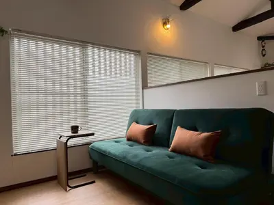 a living room with a green couch and a table at Skytree-House\u4eac\u5cf6 in Tokyo