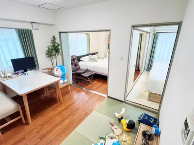 a living room with a desk and a bed and a mirror at Moto Sakura for families 3 luxury beds 2bedroom apartment in a quiet and convenient location in Tokyo
