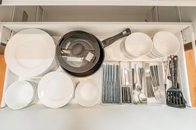 a drawer filled with plates and utensils at Mori house \u6839\u5cb8 401 in Tokyo
