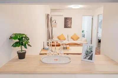a living room with a table with a picture on it at Mori house \u6839\u5cb8 401 in Tokyo