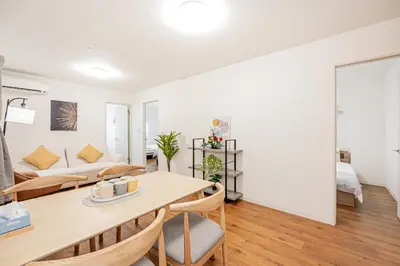 a living room with a table and a couch at Mori house \u6839\u5cb8 401 in Tokyo