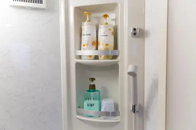 a refrigerator with towels and toiletries in a bathroom at Azur Shibuya -Apartment House- in Tokyo