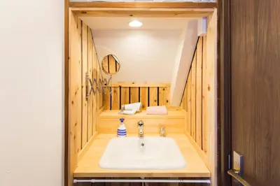 a bathroom with a sink in the middle of a room at Azur Shibuya -Apartment House- in Tokyo