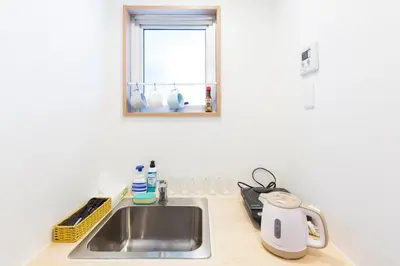 a kitchen counter with a sink and a window at Azur Shibuya -Apartment House- in Tokyo