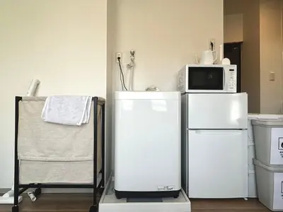 a kitchen with two white refrigerators and a microwave at \u30c8\u30e9\u30a4\u30a2\u30f3\u30b0\u30eb\u82e5\u5bae201 trianglewakamiya in Tokyo