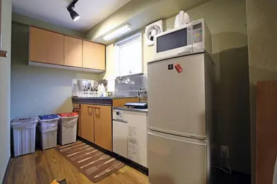 a kitchen with a white refrigerator and some trash cans at Best Value 2BR that Sleep 6, Quiet neighborhood, Close to Metro in Tokyo
