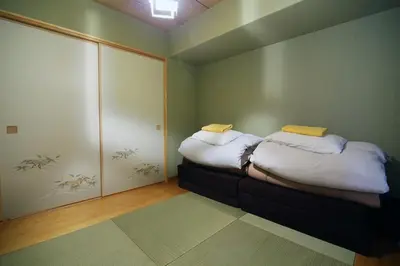 a small room with a bed with white pillows at Best Value 2BR that Sleep 6, Quiet neighborhood, Close to Metro in Tokyo