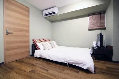 a bedroom with a white bed and a tv at Best Value 2BR that Sleep 6, Quiet neighborhood, Close to Metro in Tokyo