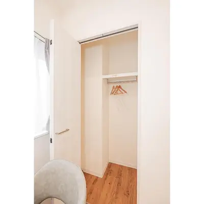 a room with a closet and a chair at Mori house \u6839\u5cb8 402 in Tokyo