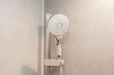 a metal door opener is attached to a wall at Mori house \u6839\u5cb8 402 in Tokyo
