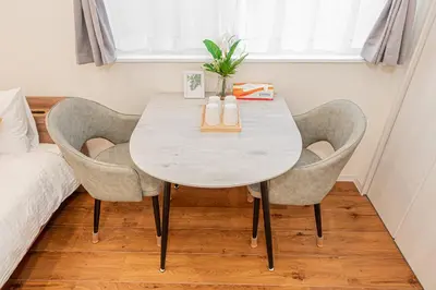 a table and chairs in a room with a bed at Mori house \u6839\u5cb8 402 in Tokyo