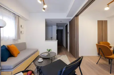 a living room with a couch and a table at \u30a2\u30fc\u30d0\u30cd\u30c3\u30af\u30b9\u9326\u7cf8\u753aNorth in Tokyo
