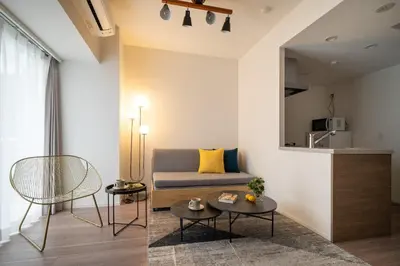 a living room with a couch and a table at \u30a2\u30fc\u30d0\u30cd\u30c3\u30af\u30b9\u9326\u7cf8\u753aNorth in Tokyo