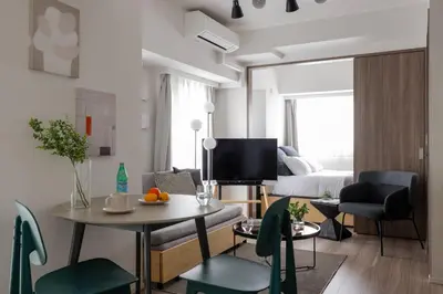 a living room with a table and chairs and a couch at \u30a2\u30fc\u30d0\u30cd\u30c3\u30af\u30b9\u9326\u7cf8\u753aNorth in Tokyo