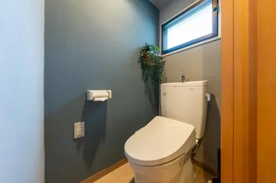 a bathroom with a white toilet and a window at Sakura Fan 2F in Tokyo