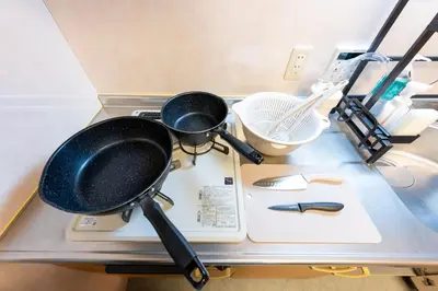 a stove top with two pans on top of it at Sakura Fan 2F in Tokyo
