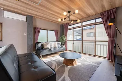 a living room with a couch and a table at Comfort Stay \u4e2d\u91ce in Tokyo