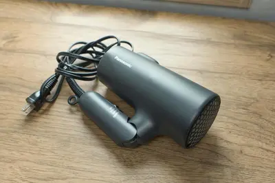 a hair dryer sitting on a wooden table at Comfort Stay \u4e2d\u91ce in Tokyo