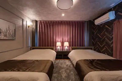 two beds in a small room with two lamps at Comfort Stay \u4e2d\u91ce in Tokyo